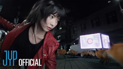 A NiziU member in a red leather jacket on a night street full of foxes in the Sour Grapes music video