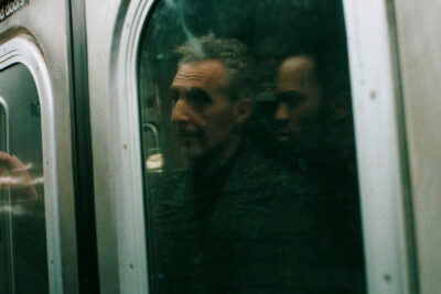 John Turturro as the pickpocket Harry Lehman, seen through a New York subway car window in Noah Segan's The Only Living Pickpocket in New York
