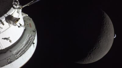 Orion spacecraft, the Moon and Earth photographed during Artemis II