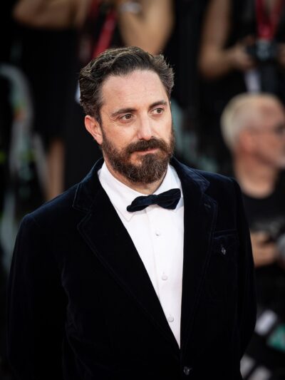 Chilean filmmaker Pablo Larraín in a velvet tuxedo on the red carpet of the 81st Venice International Film Festival, 2024