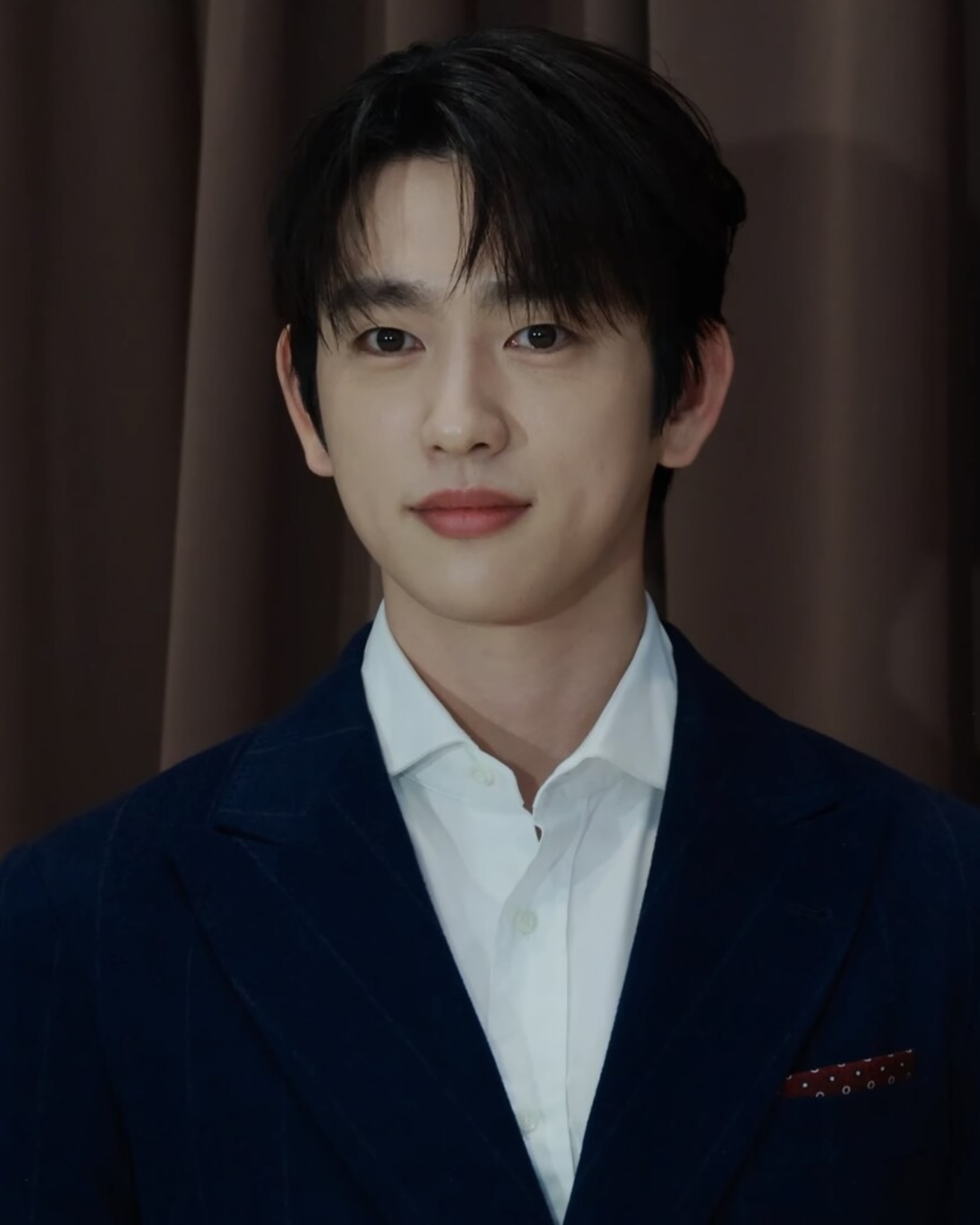 Park Jin-young, GOT7 singer and actor, in a navy suit at a Brunello Cucinelli photocall, October 2025