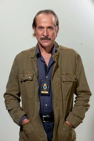 Peter Stormare in a 2015 TV3 promotional portrait for the Swedish series Black Widows, wearing a police badge
