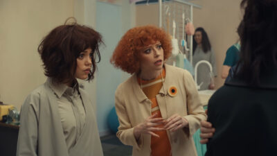 Jenna Ortega as the Artificial Friend Klara beside Natasha Lyonne as the store manager in Klara and the Sun