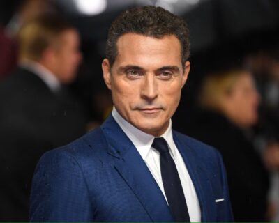 Rufus Sewell in a blue suit and dark tie on the red carpet at the London premiere of Judy, 2019