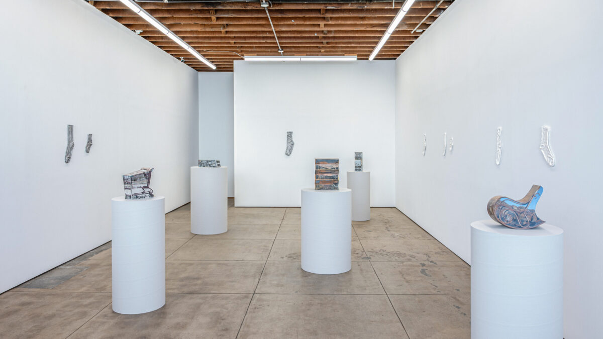 Gallery view of Ry Rocklen Desert Lenses with ceramic sculptures on plinths and cast socks on the walls