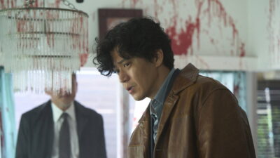 Shun Oguri as a corrupt detective in a blood-spattered room in a still from Takashi Miike's Bad Lieutenant: Tokyo