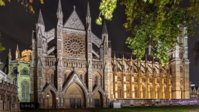 Westminster Abbey north transept and nave lit at night, seen from the lawn on its north side