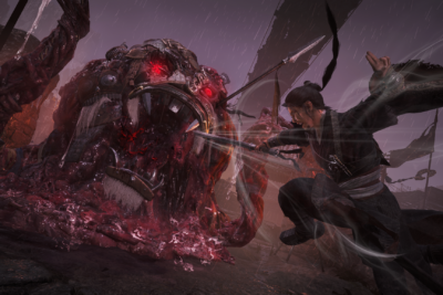 Wo Long 2: Wings of Ember screenshot: a warrior leaps at a giant red-eyed demon in the rain