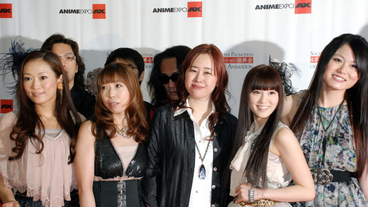 Composer Yuki Kajiura stands at the centre of the FictionJunction singers at Anime Expo 2012
