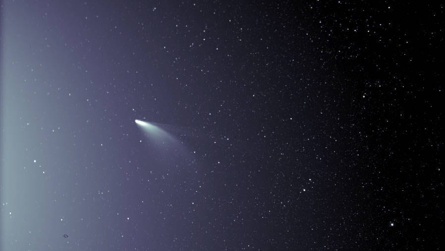 An unprocessed image from the WISPR instrument on board NASA’s Parker Solar Probe shows comet NEOWISE on July 5, 2020, shortly after its closest approach to the Sun. The Sun is out of frame to the left. The faint grid pattern near the center of the image is an artifact of the way the image is created. The small black structure near the lower left of the image is caused by a grain of dust resting on the imager’s lens. Credits: NASA/Johns Hopkins APL/Naval Research Lab/Parker Solar Probe/Brendan Gallagher Download additional imagery from NASA Goddard's Scientific Visualization Studio.