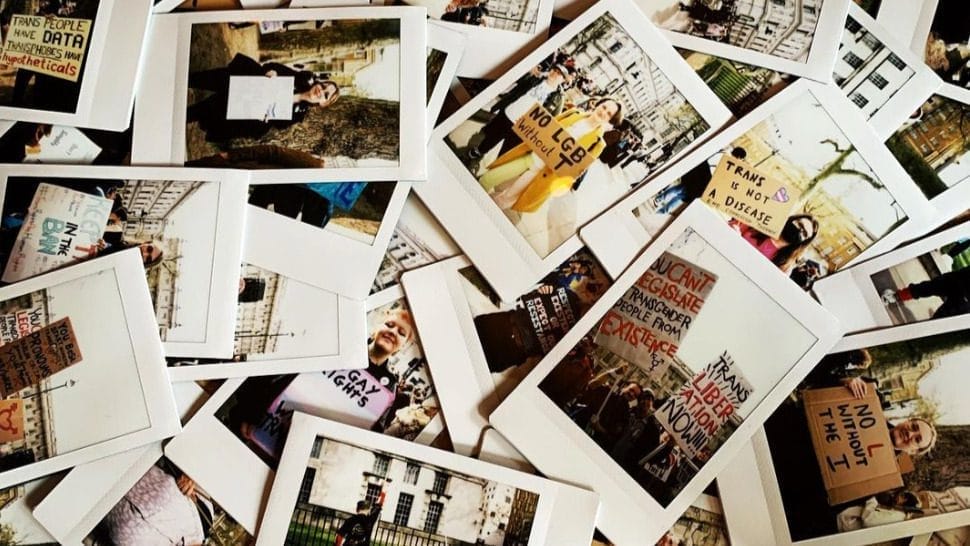 Polaroids of Protesters and their Ban Trans Conversion Therapy Placards. Courtesy of Museum of Transology.