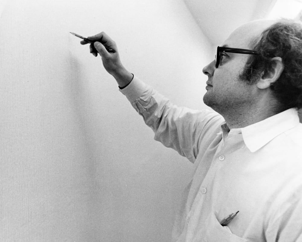 Sol LeWitt working on Wall Drawing